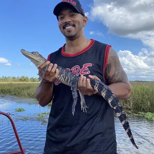 Holding a baby gator.