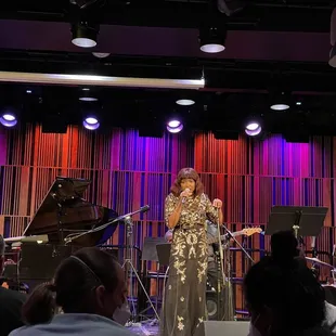 a woman singing on stage