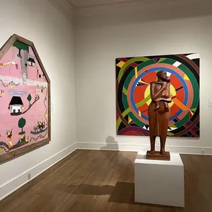 Love this mother and child sculpture with modern art in the background