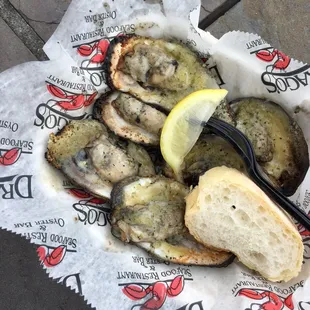 a plate of oysters with a slice of lemon