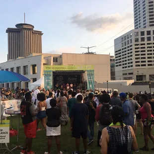 a large crowd of people standing in front of a stage