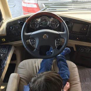My son at the helm of the 1/2 million dollar Tiffin motorhome.