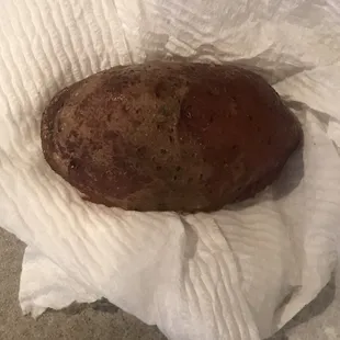 A potato with dirt still on it