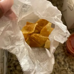 a person holding a bag of chips