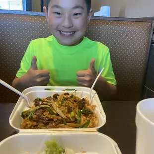 Happy boy with a mass of Mongolian beef and chicken. He left nothing behind.