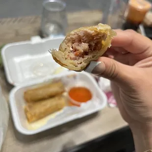 a person holding a piece of food