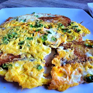 Banh Bot Chien (egg flour cakes) with dipping sauce.