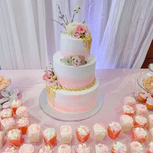 a wedding cake and cupcakes