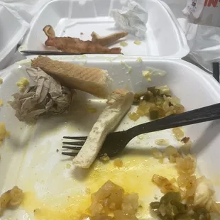 a half eaten meal in a styrofoam container