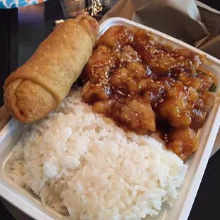 Sesame Chicken combo with white rice and an egg roll.