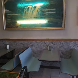 a painting of a waterfall in a restaurant