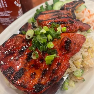 a plate of grilled meat and rice