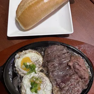 steak, eggs, and bread on a plate