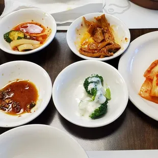 Banchan side dishes captured in middle of eating