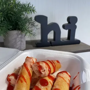 Strawberry Cheesecake Egg Roll Best desert to finish off the meal! One is not enough! Finished with Cinnamon and raspberry dressing!