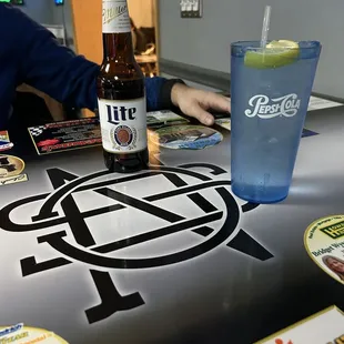 a man sitting at a table with a drink
