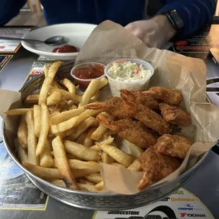 Shrimp basket with two shrimp and some fries eaten before picture was taken