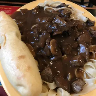 Beef tips over noodles