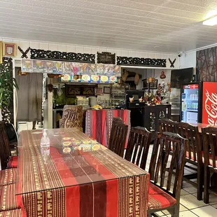 a dining area with a table and chairs