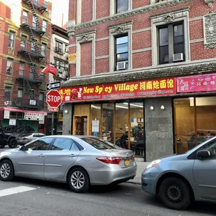 two cars parked in front of a chinese restaurant