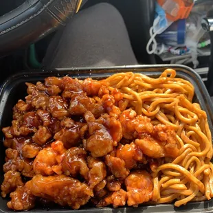 a tray of noodles and meat