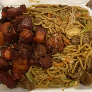 a plate of noodles and meat