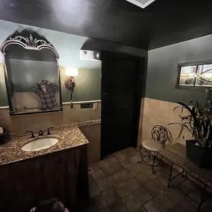 Women's Bathroom- Seat and Table, Full Sized Leaning Mirror, Beautiful Sink, Vanity Mirror, Sconces. Clean and well kept.