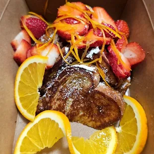 This weekend's special - orange French toast with strawberries. Whipped cream packed separately.