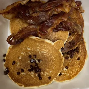 Short stack of chocolate chip pancakes with bacon