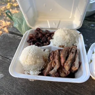 a tray of rice, meat, and beans