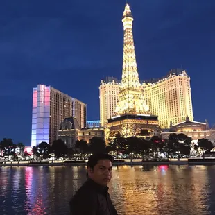 a man standing in front of the eiffel tower