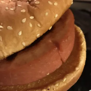 a hand holding a sandwich