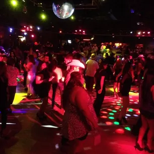 a crowd of people dancing at a party