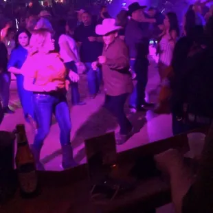 a group of people dancing at a party