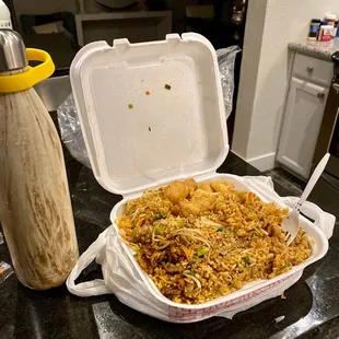 Combination fried rice with egg rolls and sweet and sour chicken