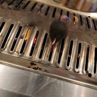 a grill with hot dogs on it