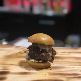 a hamburger on a wooden table