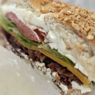 Cross section of Soho BLT on double toasted garlic bagel with cheddar, add cream cheese