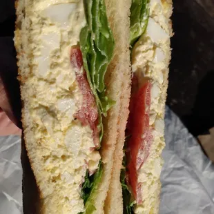 Egg Salad on White with lettuce and tomato.