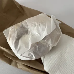 Unwrapped egg bagel with lox cream cheese.
