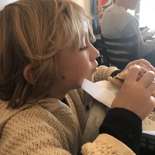 Five-year-old son putting himself into a bagel coma, with a second cheddar bacon