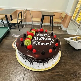 a chocolate cake with fruit on top