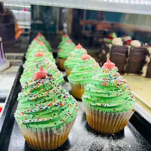 cupcakes with green frosting and sprinkles