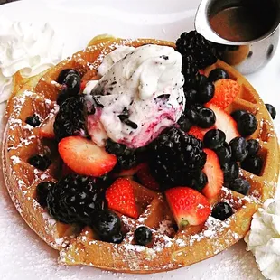 a waffle with berries and ice cream