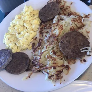 Breakfast combo eggs, meat,  hash browns and toast. Hash browns could have been cooked longer.