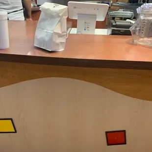 a counter with a paper bag on it
