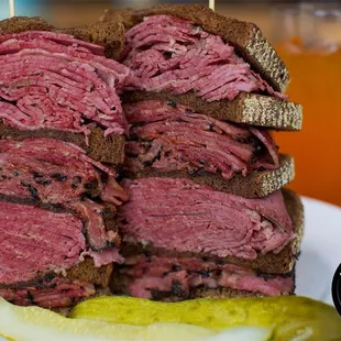 a plate of pastrami sandwiches