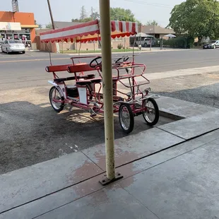 a tricycle parked on the side of the road