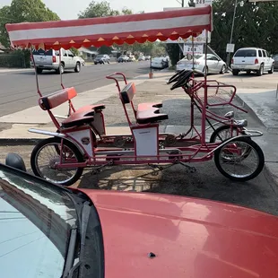 a tricycle parked on the side of the road