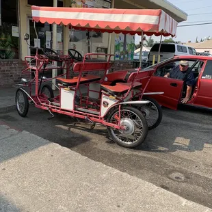 a three wheeled vehicle parked in front of a store
